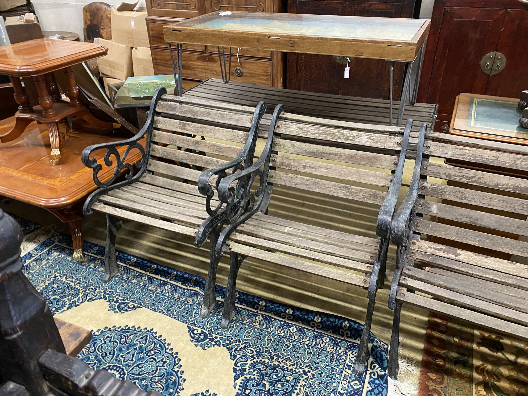 A cast metal slatted garden bench, length 130cm, depth 64cm, height 78cm, matching table and two chairs